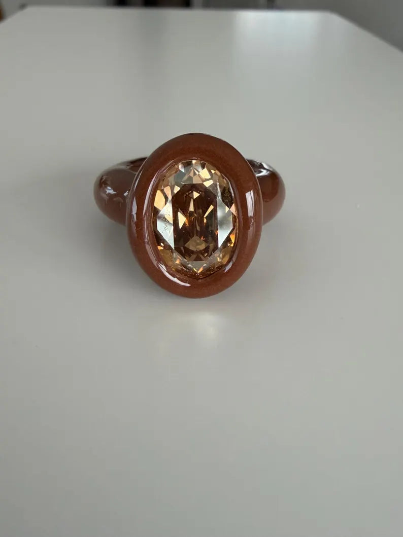Espresso brown polymer ring with champagne crystal in oval shape