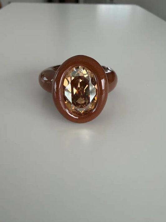 Espresso brown polymer ring with champagne crystal in oval shape