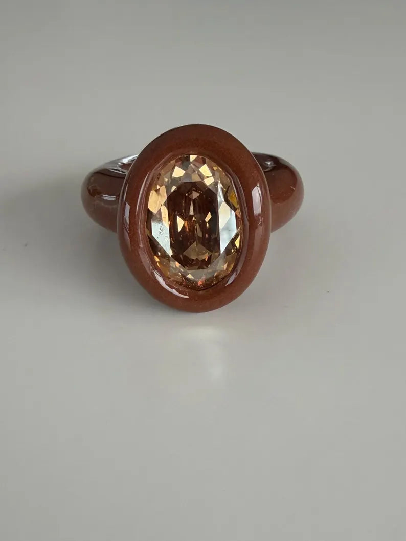 Espresso brown polymer ring with champagne crystal in oval shape