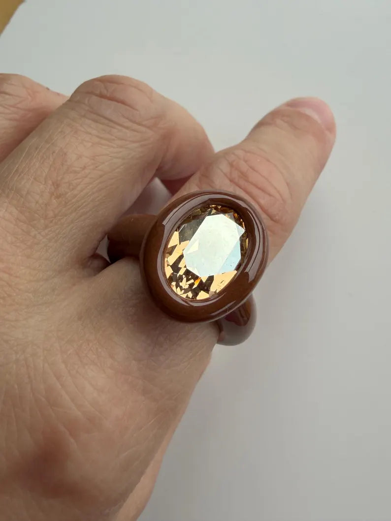 Espresso brown polymer ring with champagne crystal in oval shape