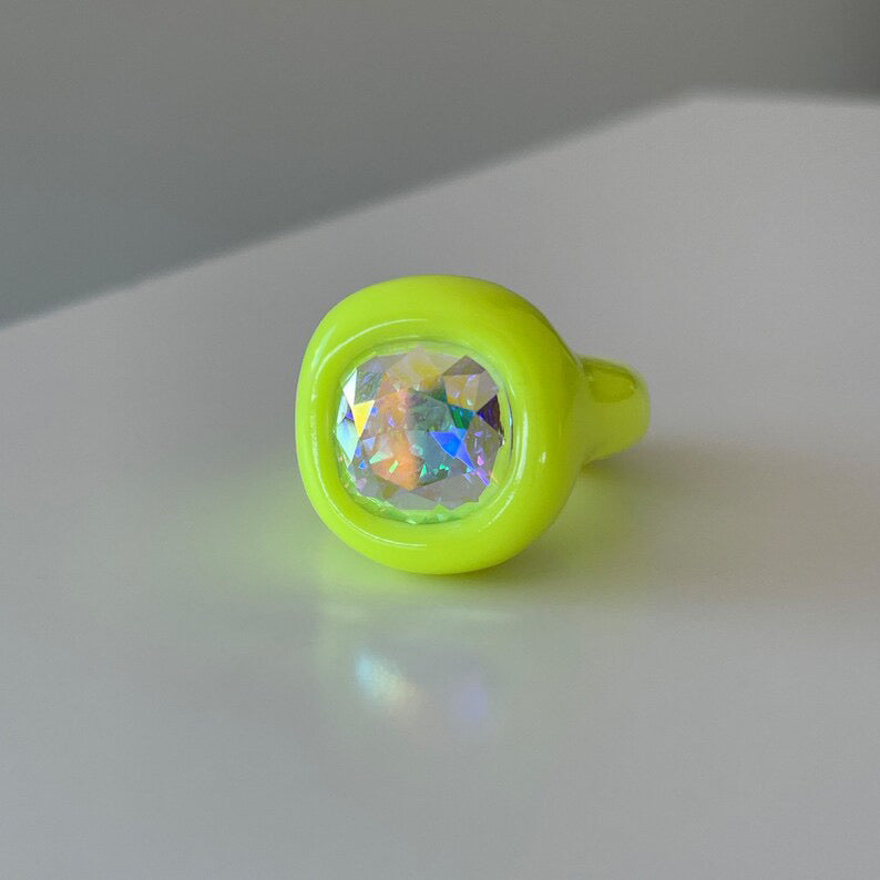 Neon yellow polymer ring with opalescent 12 mm crystal