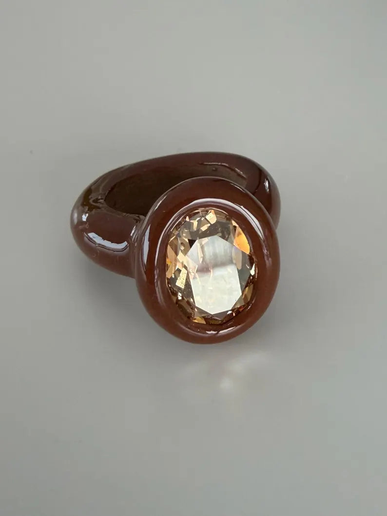 Espresso brown polymer ring with champagne crystal in oval shape
